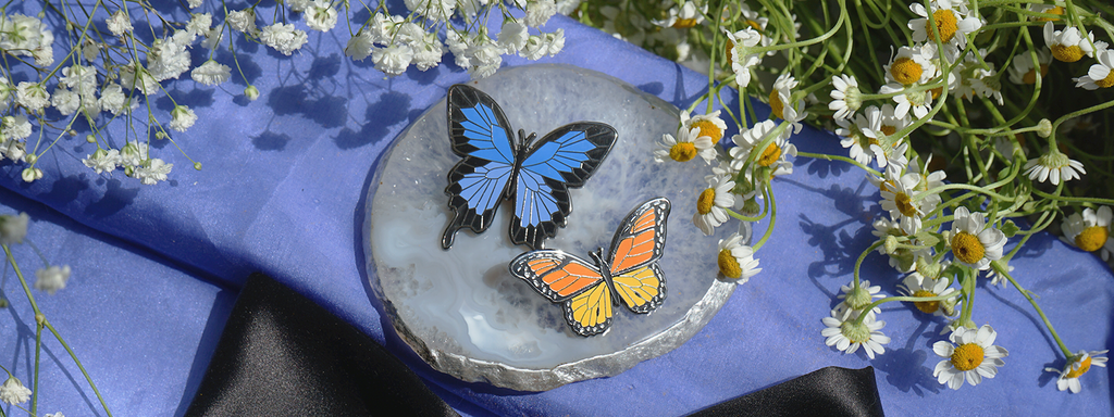 Picture of blue swallowtail and orange monarch enamel pins