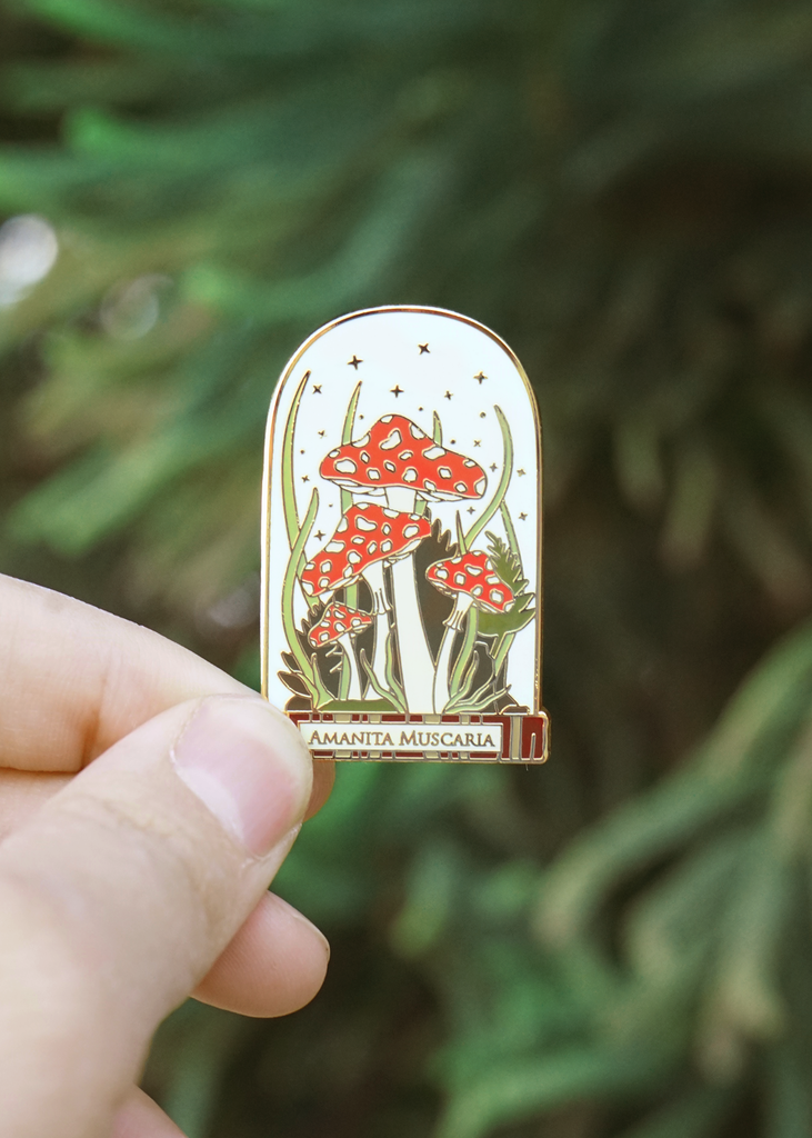 Red mushrooms in belljar pin
