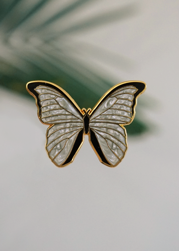 White morpho on gold colored metal with white pearl swirl enamel