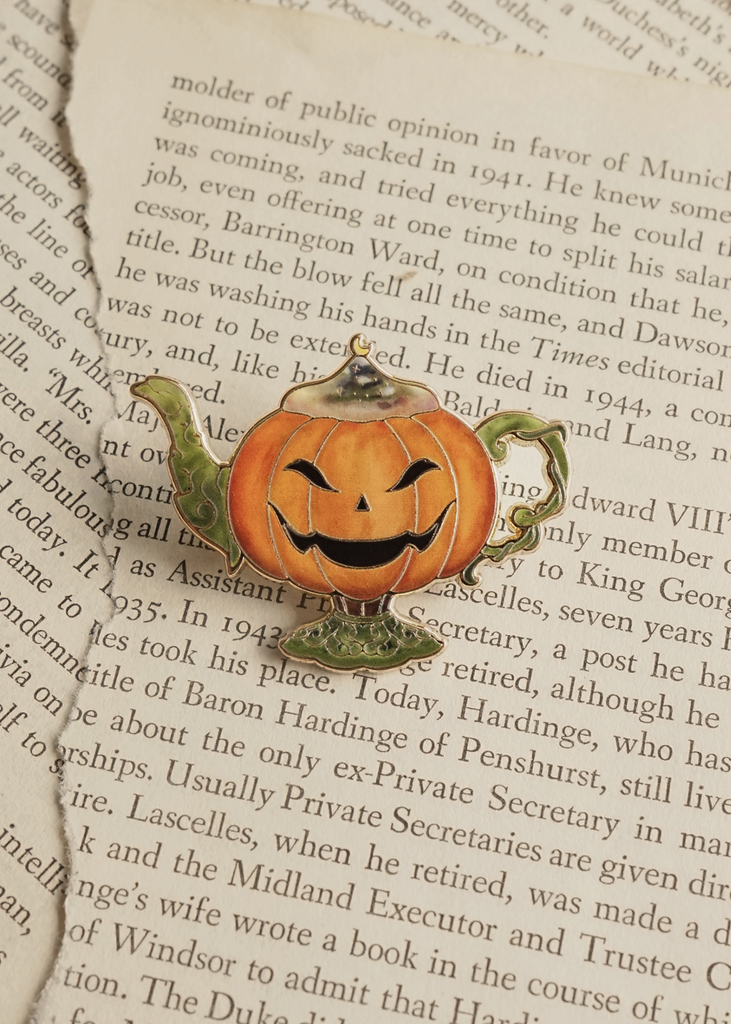 Pumpkin lamp pin on torn book pages