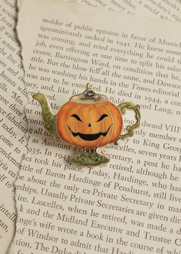 Pumpkin lamp pin on torn book pages
