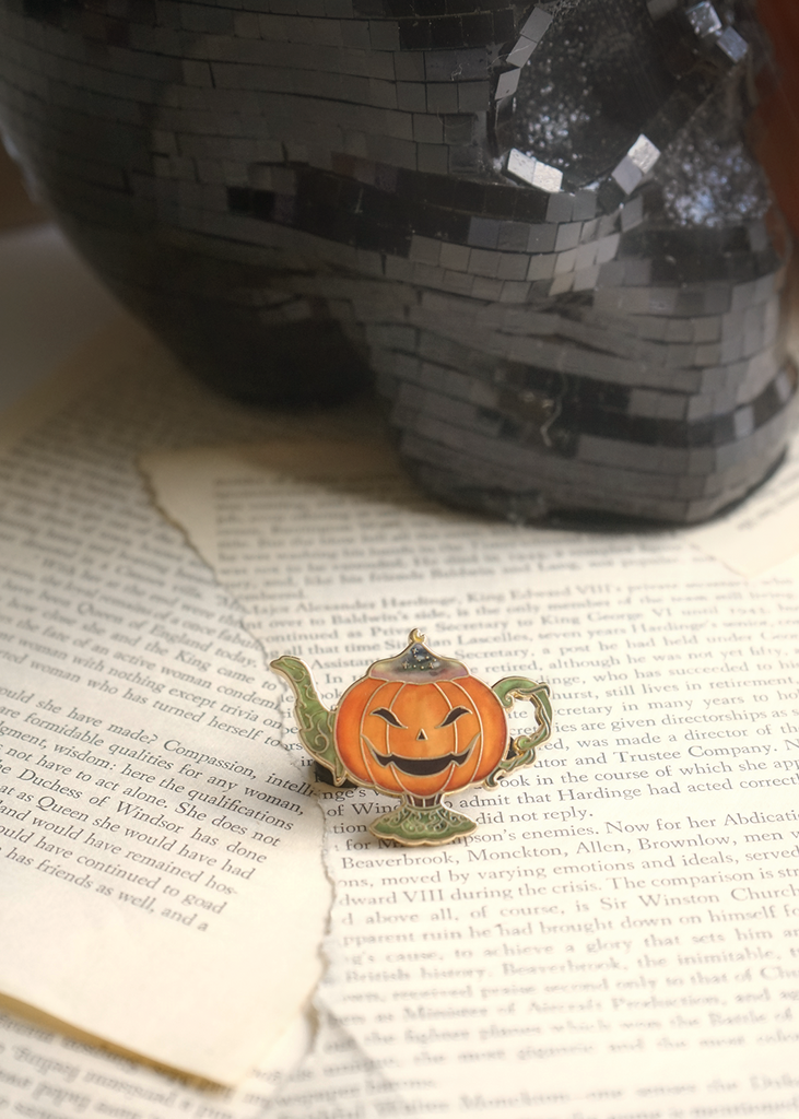 Pumpkin lamp pin on torn book pages
