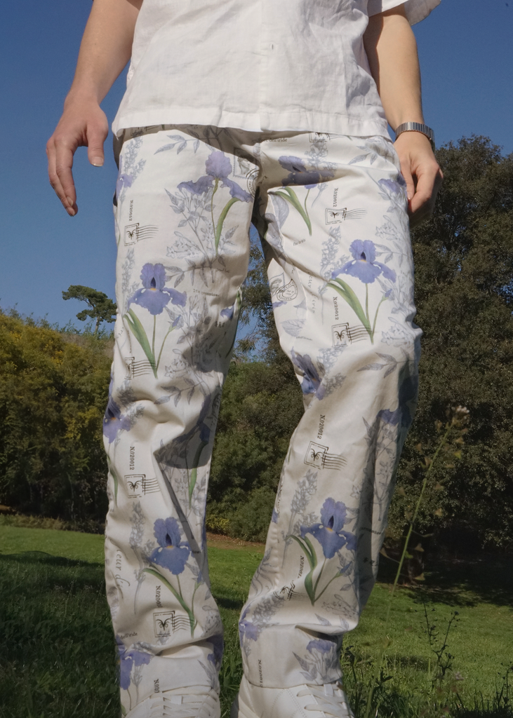 Close up of Thomas wearing Atlas trousers in iris botany print