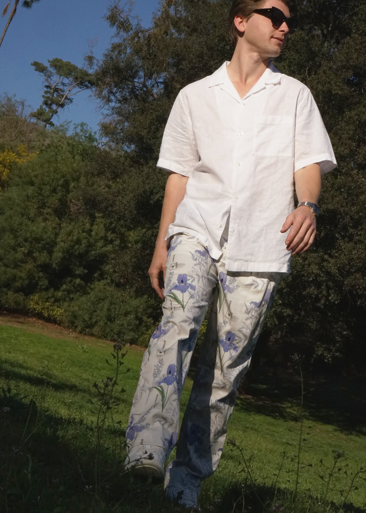 Thomas wearing Atlas trousers in iris botany print