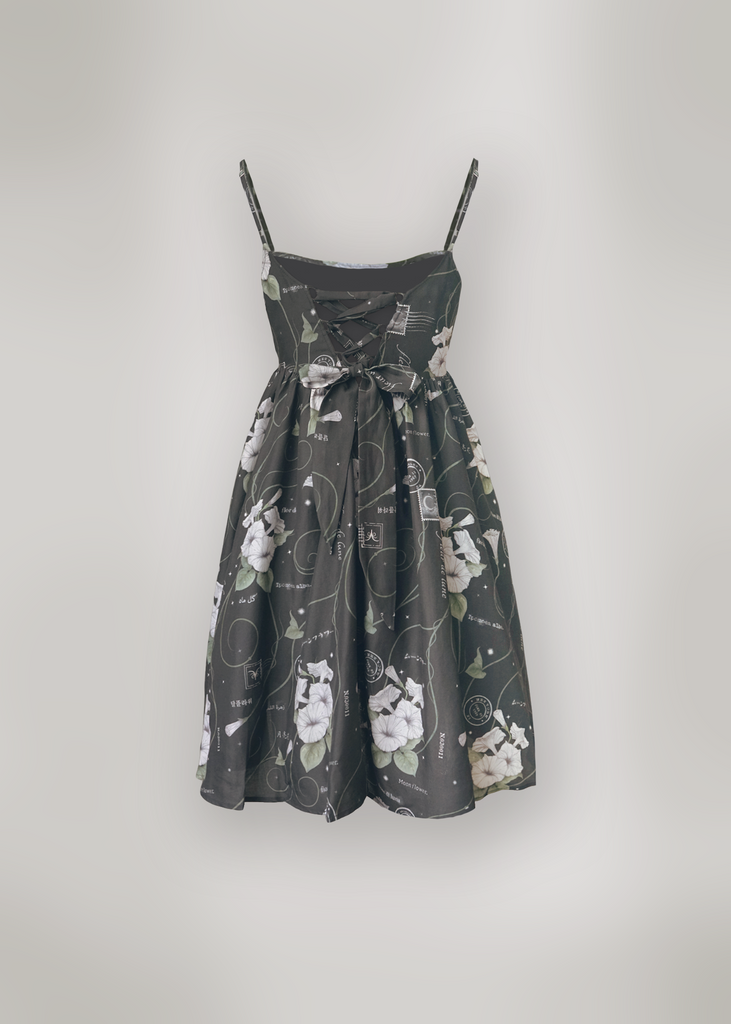 Back of Marili mini dress in midnight magic print in front of backdrop