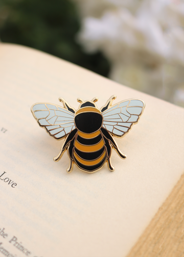 Close up shot of front of honey bee enamel pin