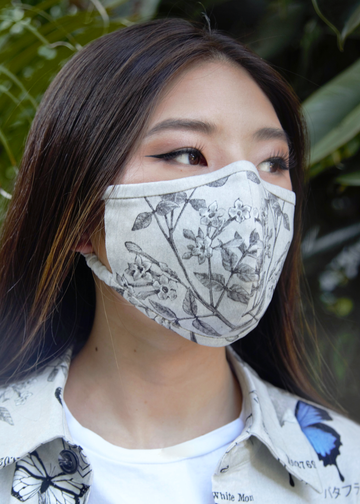 Model wearing jasmine print cotton mask with stretchy straps
