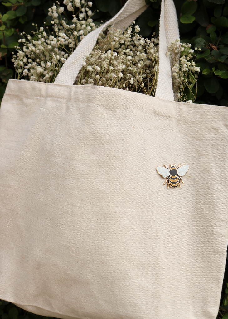 Medium shot of honey bee pin on tote bag