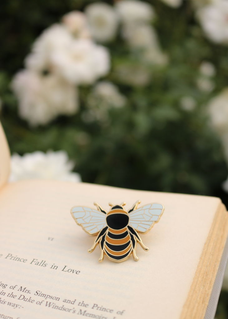Close up of honey bee pin on book